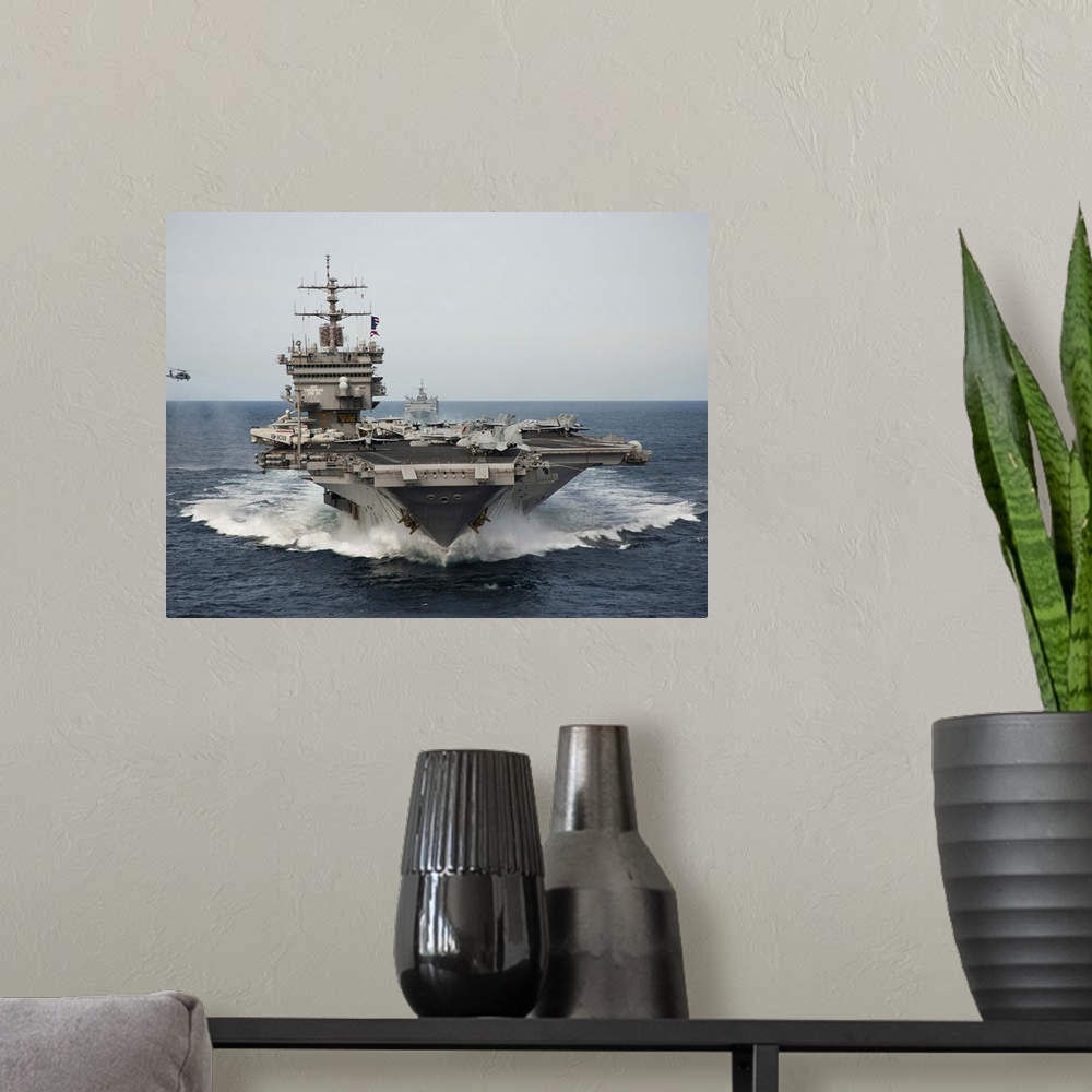 A modern room featuring USS Enterprise transits the Atlantic Ocean.