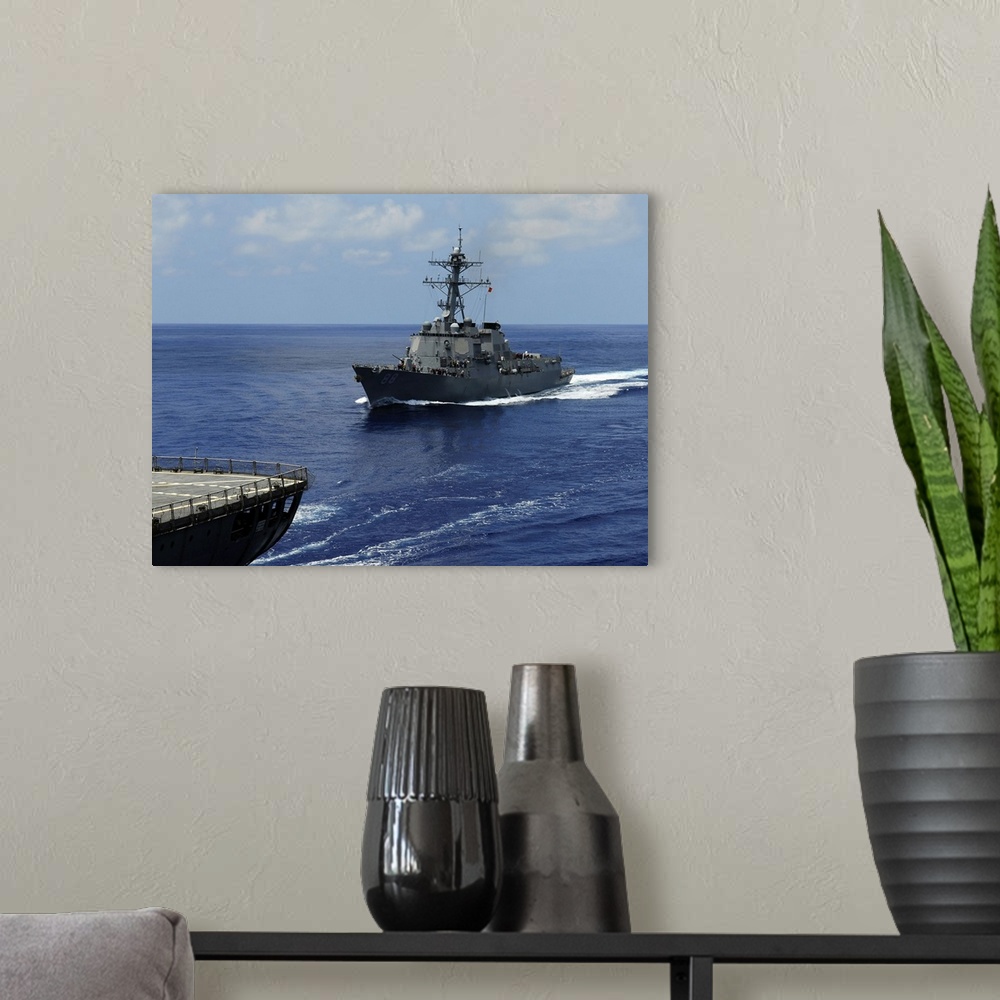 A modern room featuring Guided-missile destroyer USS Preble approaching the Military Sealift Command oiler USNS John Eric...