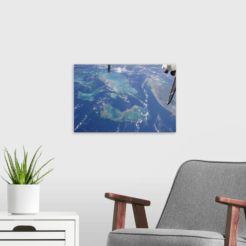 A modern room featuring July 12, 2011 - View from space featuring The Tongue of the Ocean and several of the 2,700 island...
