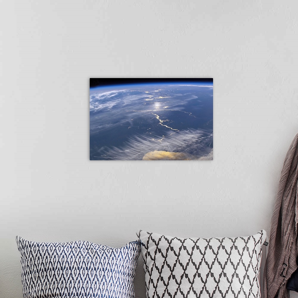 A bohemian room featuring This large piece is a photograph taken of the earths surface from space.