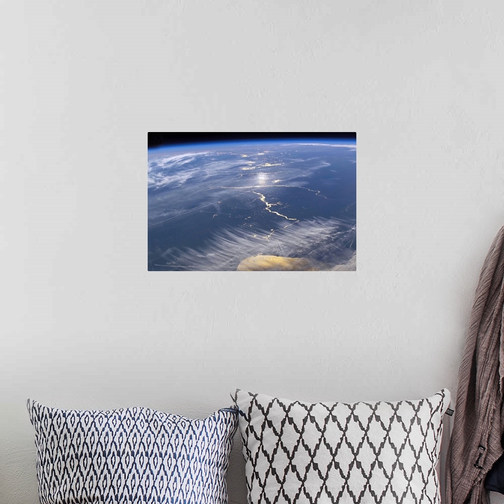 A bohemian room featuring This large piece is a photograph taken of the earths surface from space.