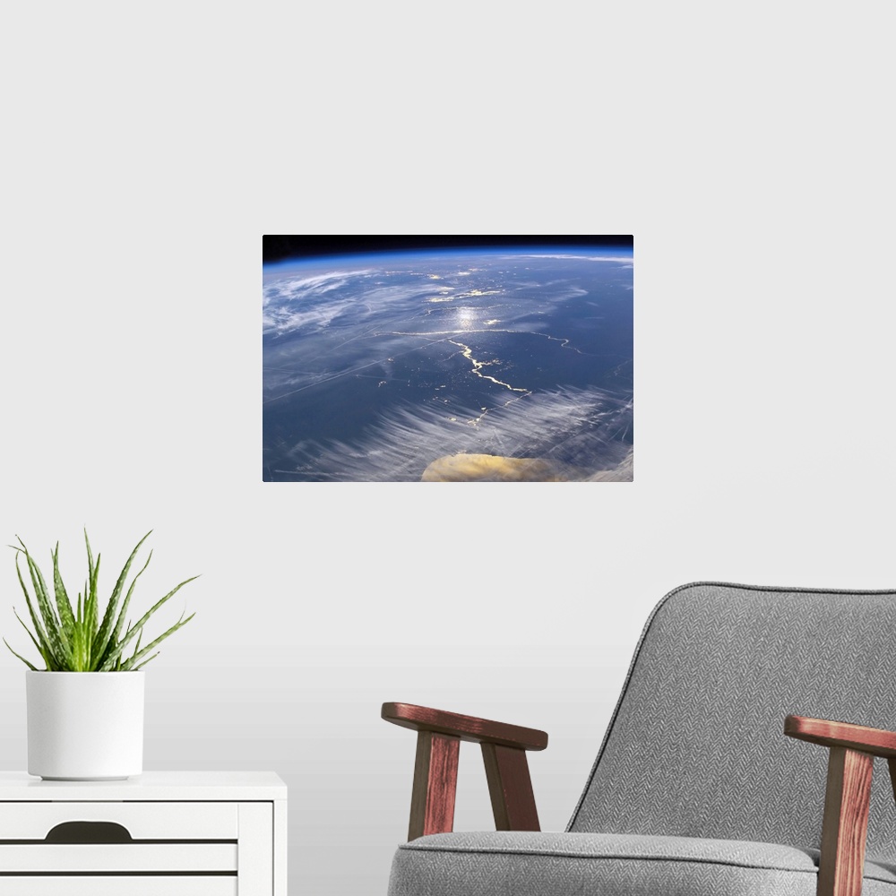 A modern room featuring This large piece is a photograph taken of the earths surface from space.