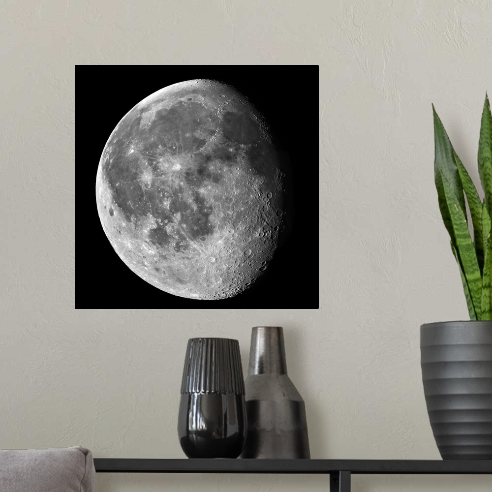 A modern room featuring A partially shaded moon is photographed against a black background.