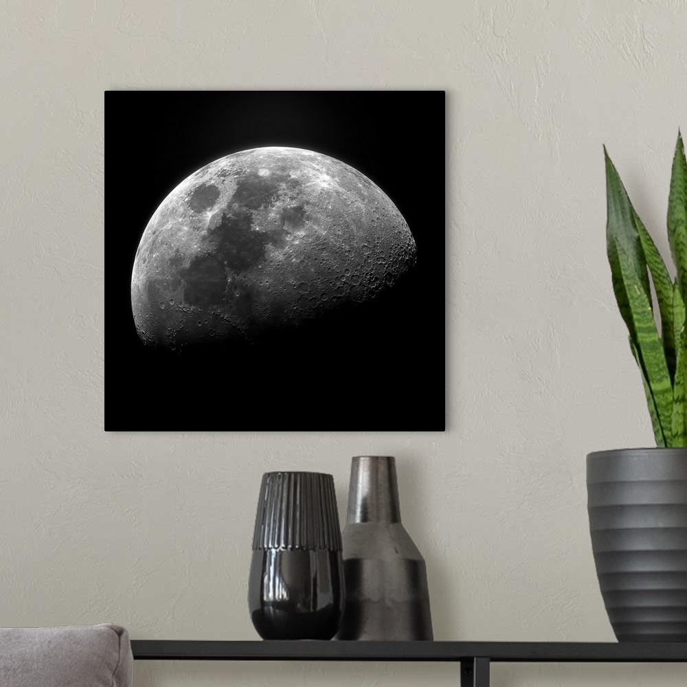 A modern room featuring Clear photograph of one of the moon's phases showing well-defined craters, fading to the shadowy ...
