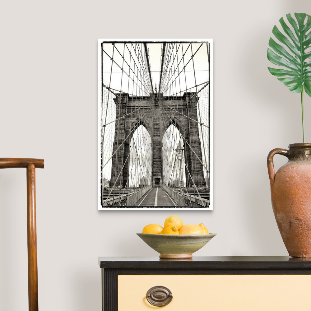 A traditional room featuring Black and white photograph of a dramatic view of the Brooklyn Bridge.