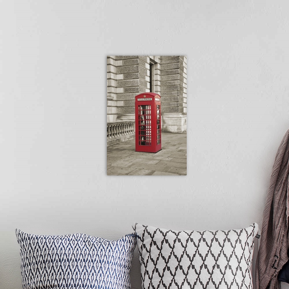 A bohemian room featuring Photo of a phone booth colored red in London, England.