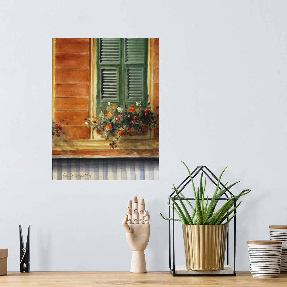 A bohemian room featuring A painting of flowers that sit in a pot just below a window with green shutters that are closed.