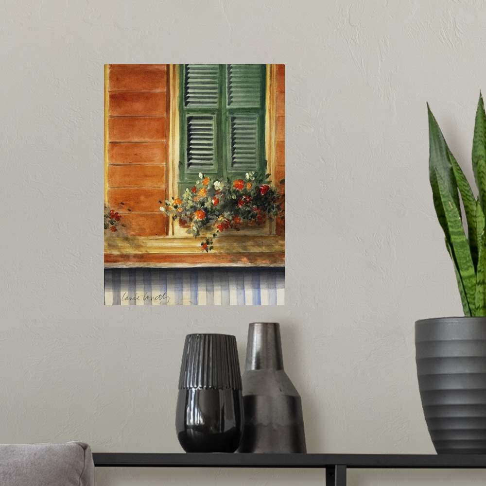 A modern room featuring A painting of flowers that sit in a pot just below a window with green shutters that are closed.