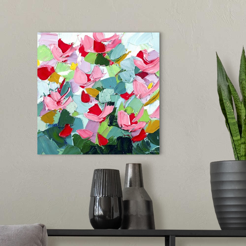 A modern room featuring Brightly colored abstract artwork with pink flowers on green.