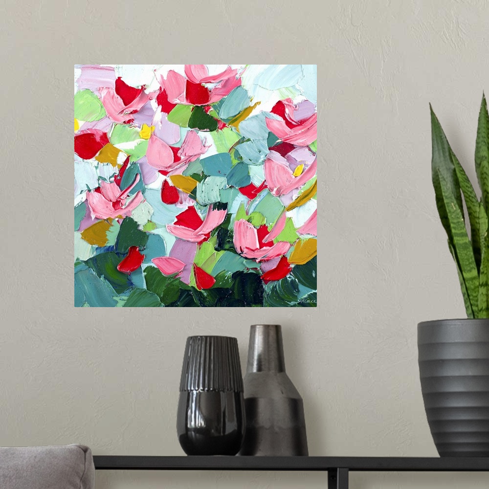 A modern room featuring Brightly colored abstract artwork with pink flowers on green.