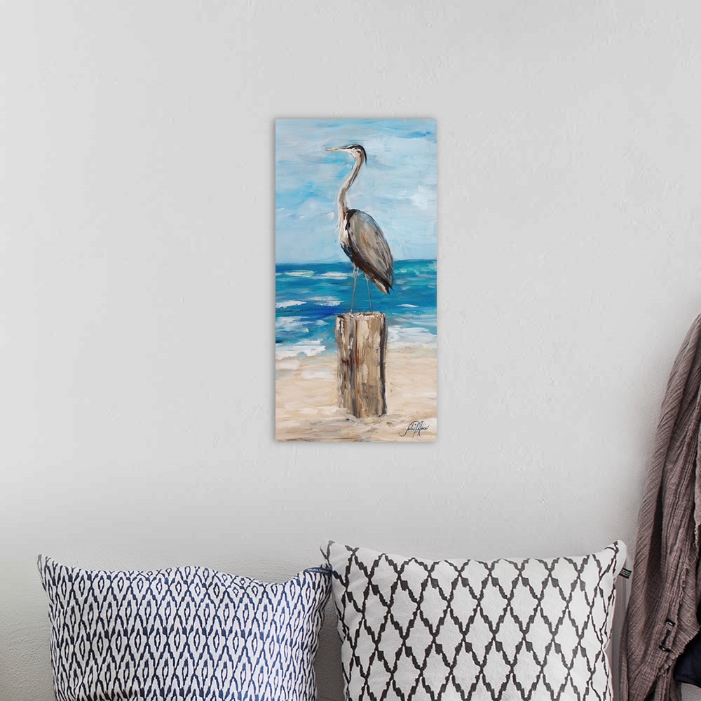 A bohemian room featuring Contemporary painting of a heron standing on wooden post on a beach.