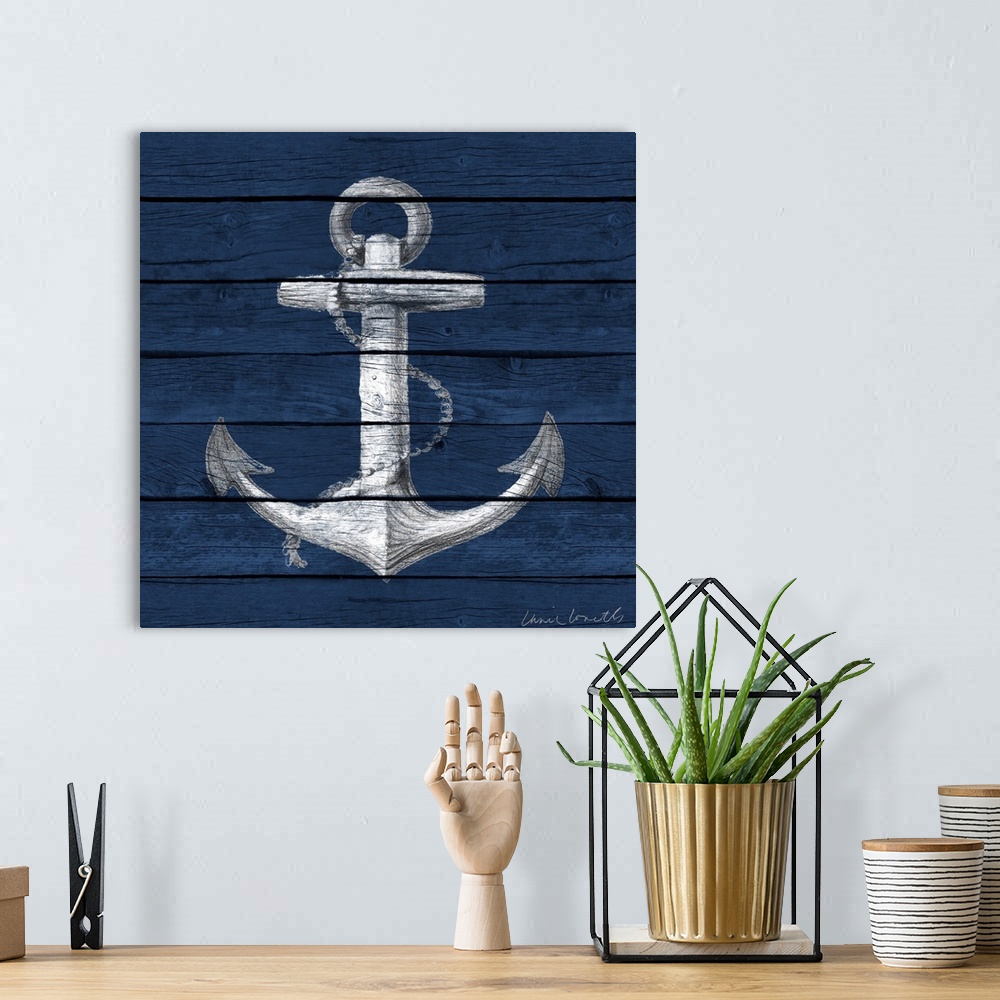 A bohemian room featuring A painting of an anchor on a blue wood paneled background.