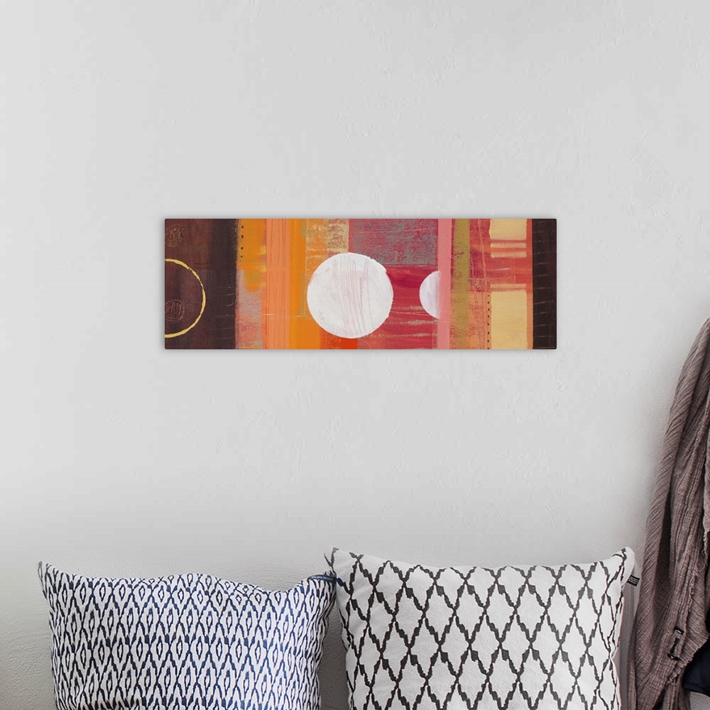 A bohemian room featuring Abstract painting in warm orange and brown shades, with circular shapes and blocks of color.