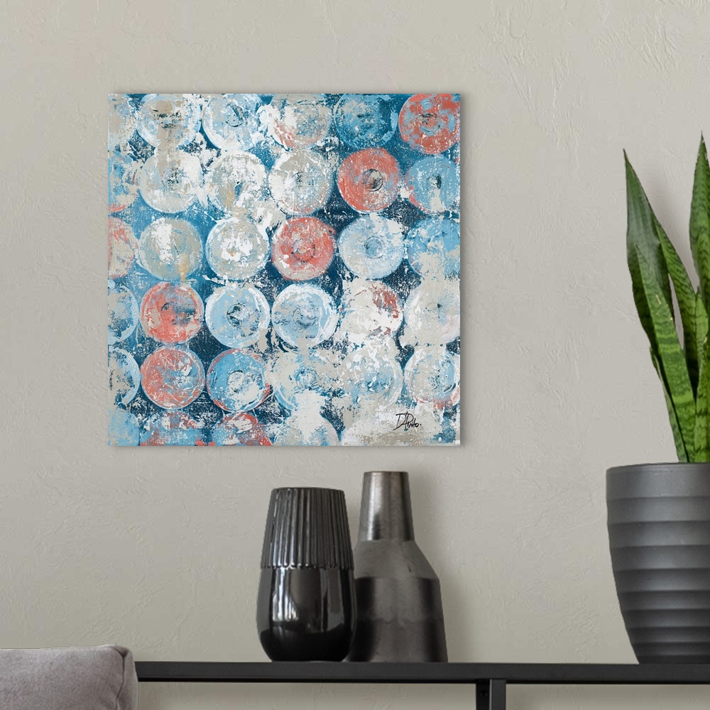 A modern room featuring A square abstract painting with an antique feel and blue, gray, and salmon colored circles.