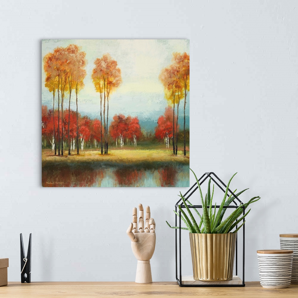 A bohemian room featuring Painting of a countryside clearing with tall and short trees in autumn foliage in front a river.