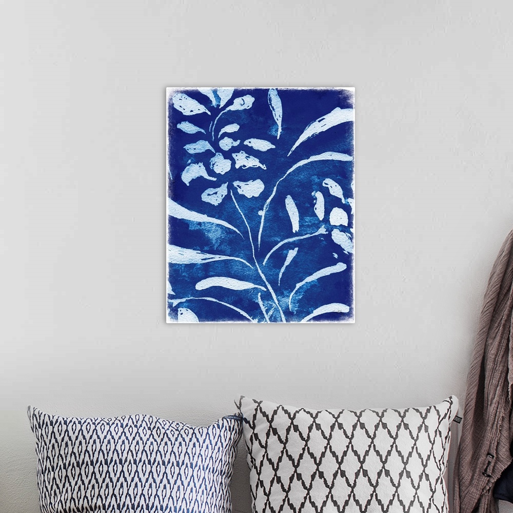 A bohemian room featuring White silhouette painting of flowers and leaves on an indigo background.