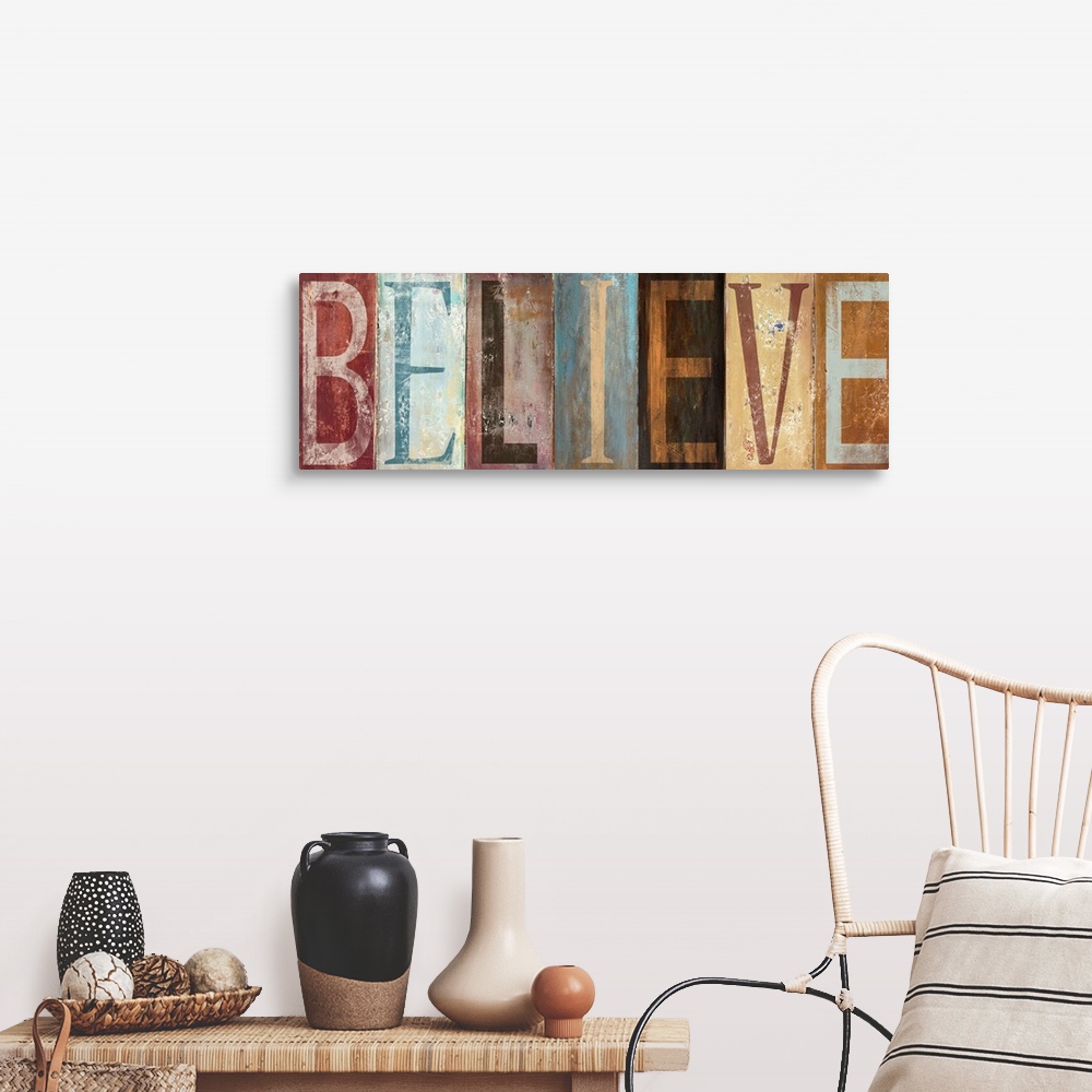 A farmhouse room featuring The word "Believe" with each letter painted in a different style in muted colors, with a worn, we...