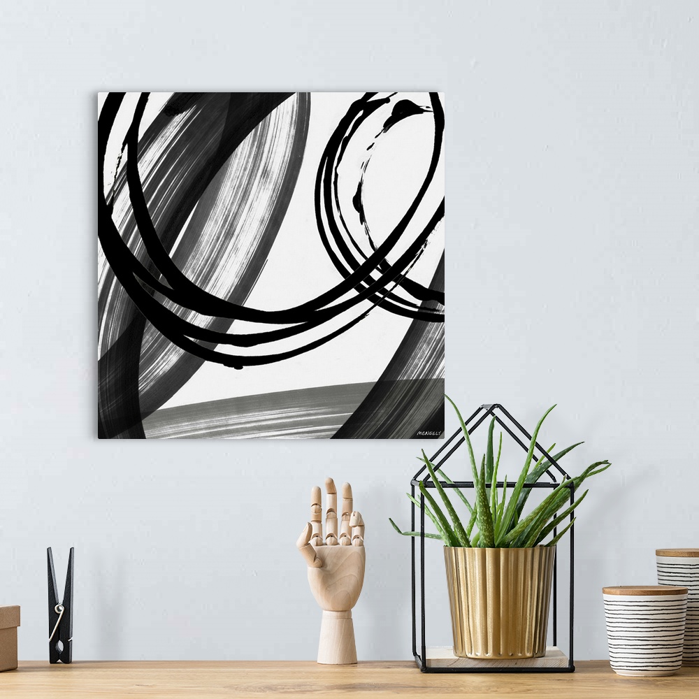A bohemian room featuring A contemporary abstract painting with big circles using black and white hues.