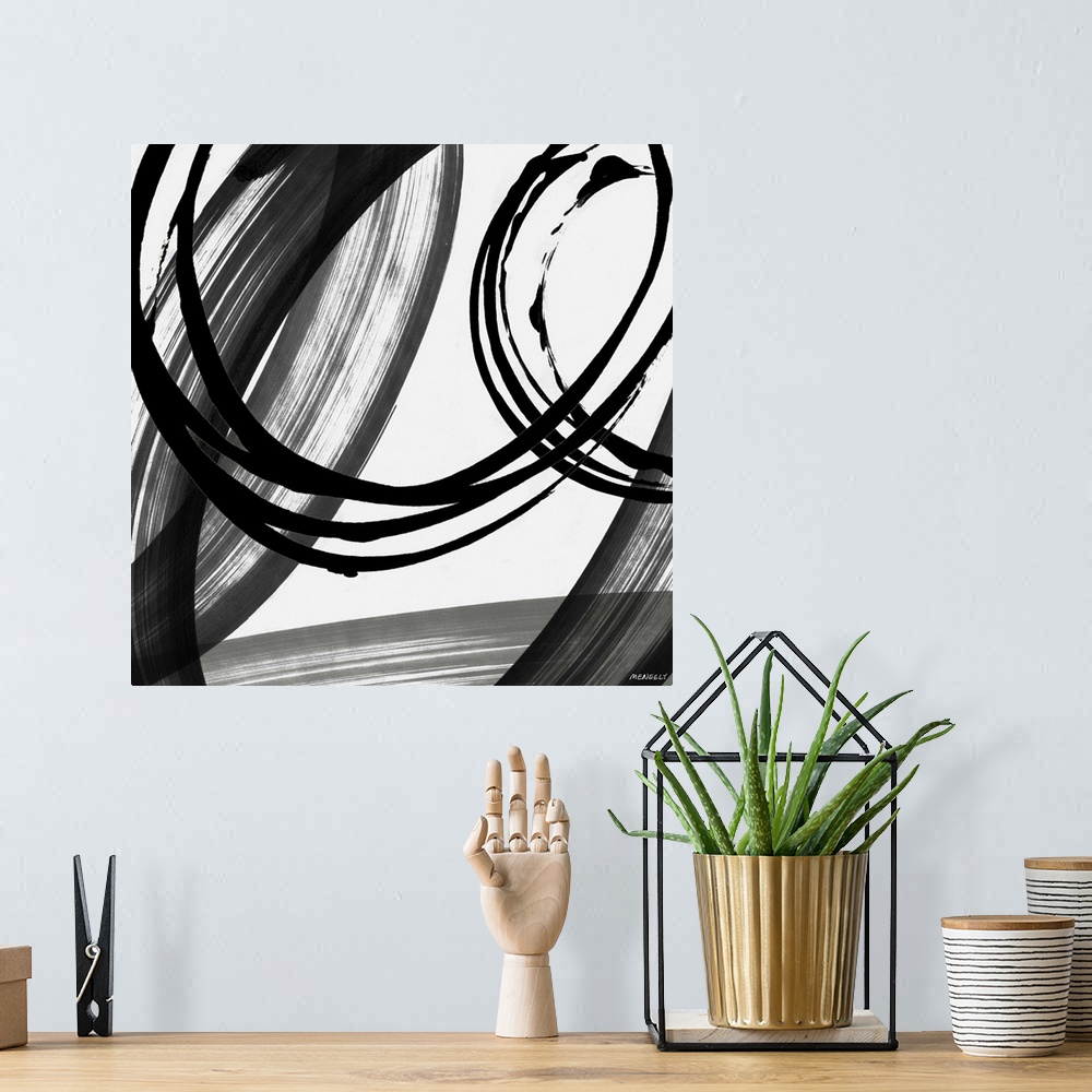 A bohemian room featuring A contemporary abstract painting with big circles using black and white hues.