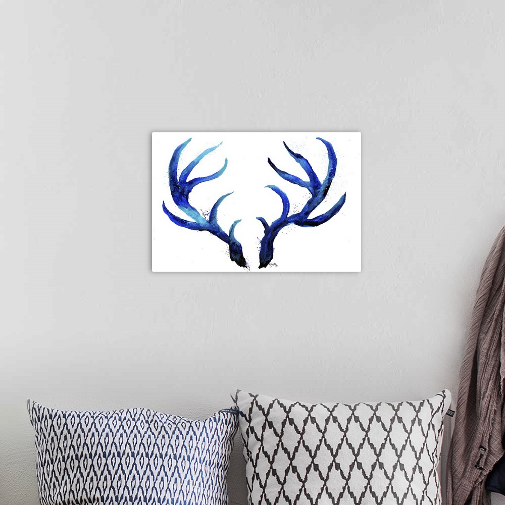 A bohemian room featuring Watercolor painting of a set of blue antlers with light paint splatter around on a white background.
