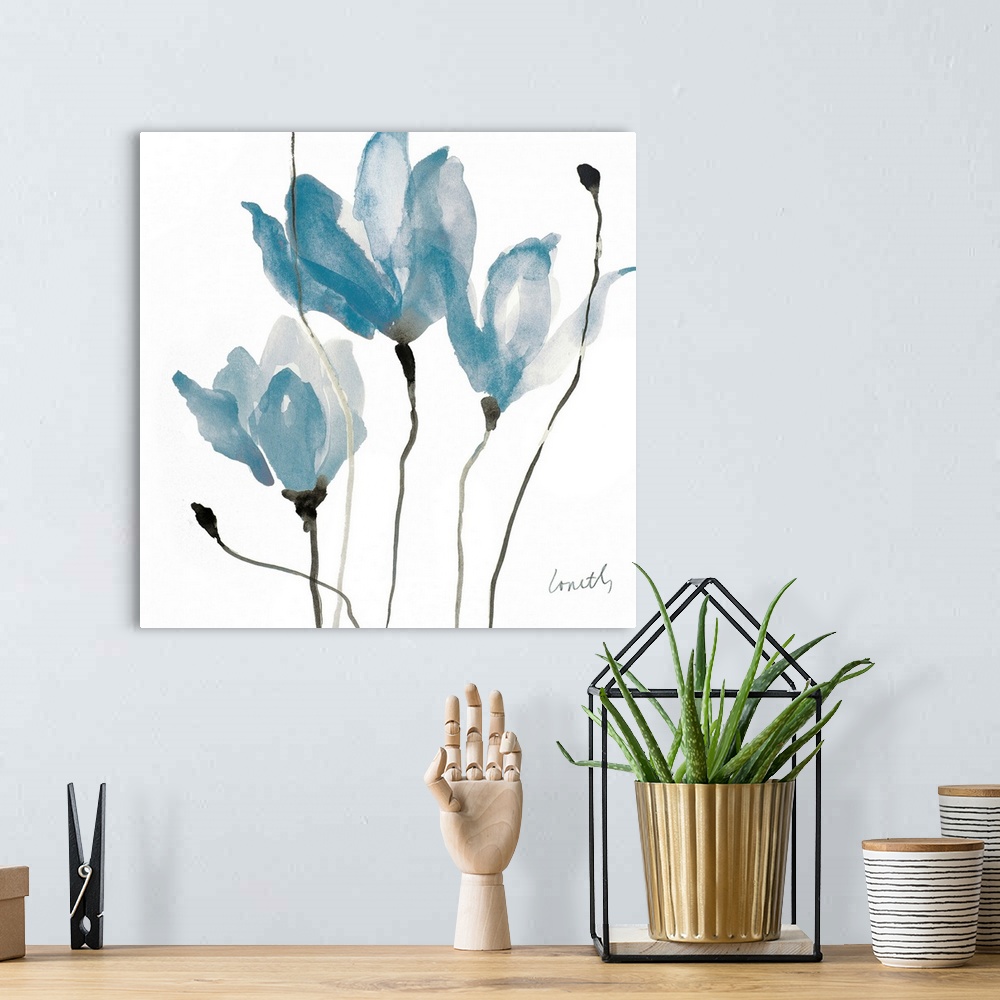 A bohemian room featuring A square watercolor painting of three blue flowers with thin, black stems.