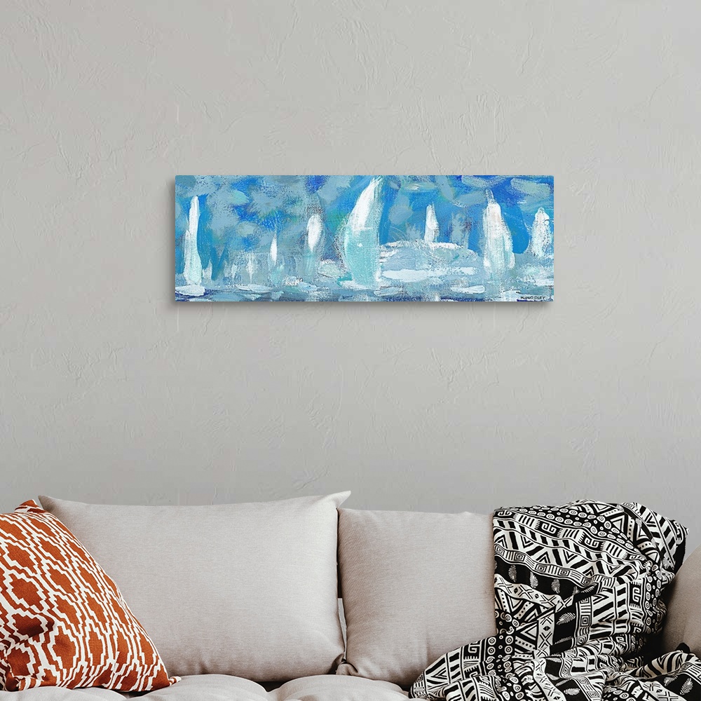 A bohemian room featuring Horizontal artwork of a group of white sailboats against a blue sky.