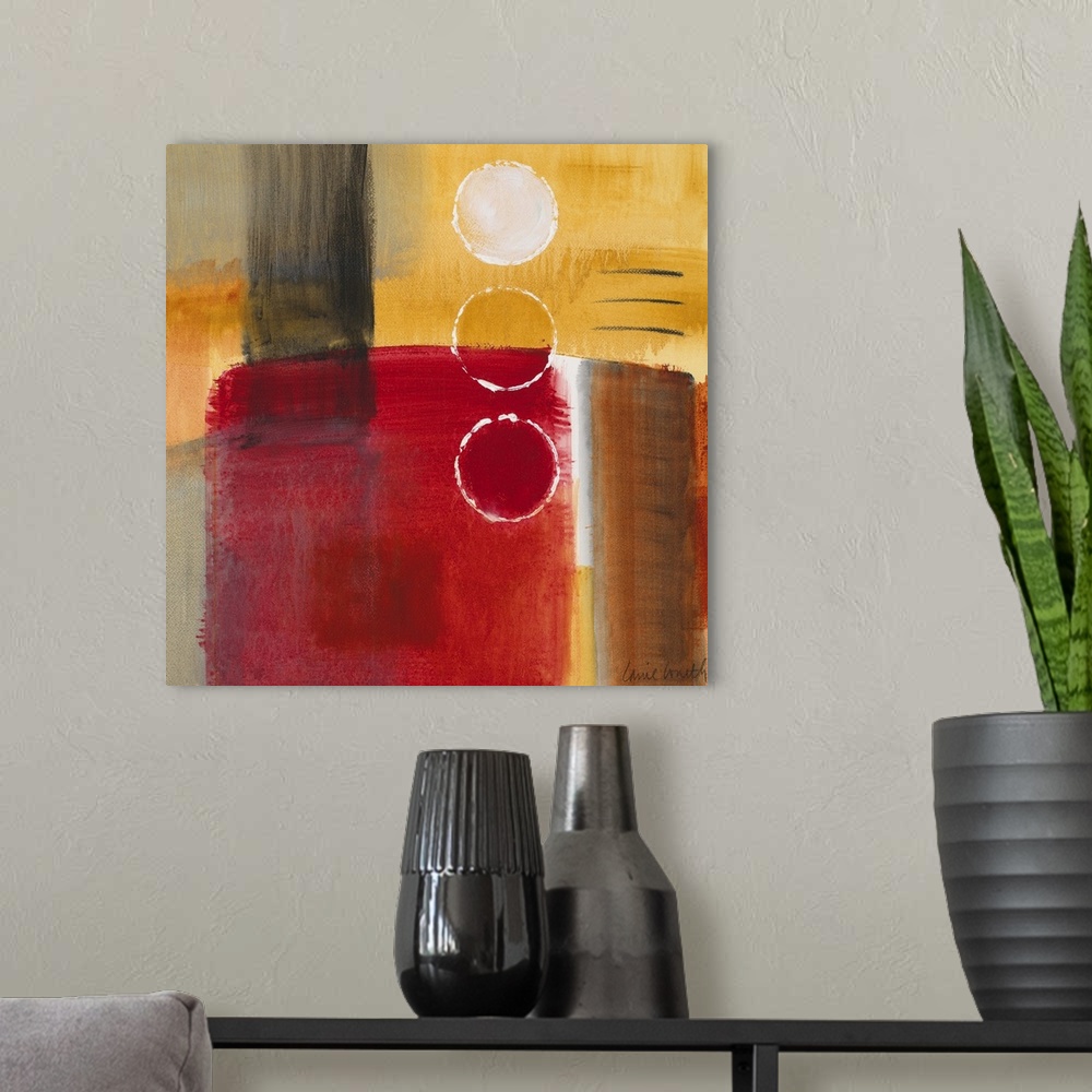 A modern room featuring Square abstract painting on a big canvas in primarily warm tones.  A large cylindrical object is ...