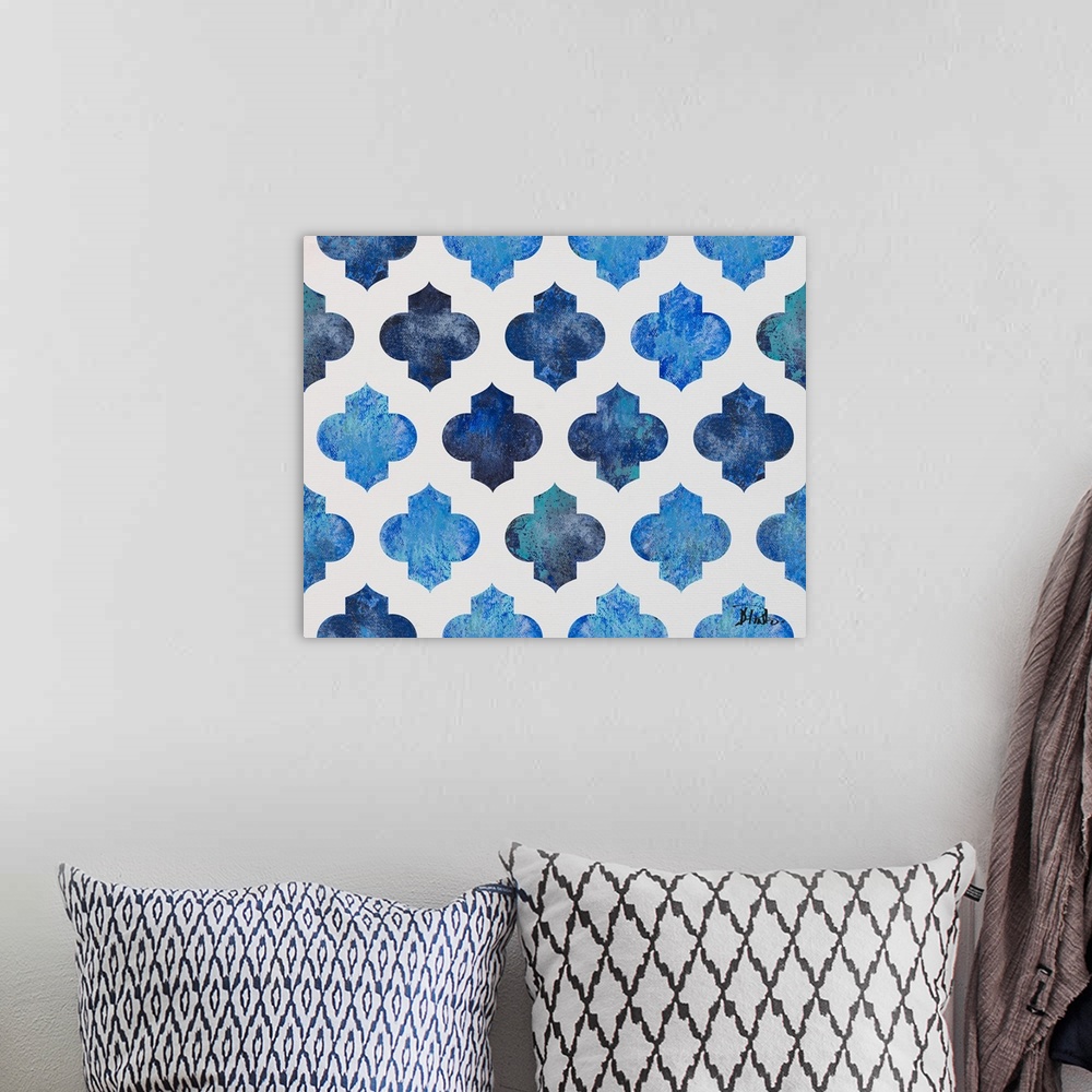A bohemian room featuring A symmetric quatrefoil pattern with various shades of blue on a white background.