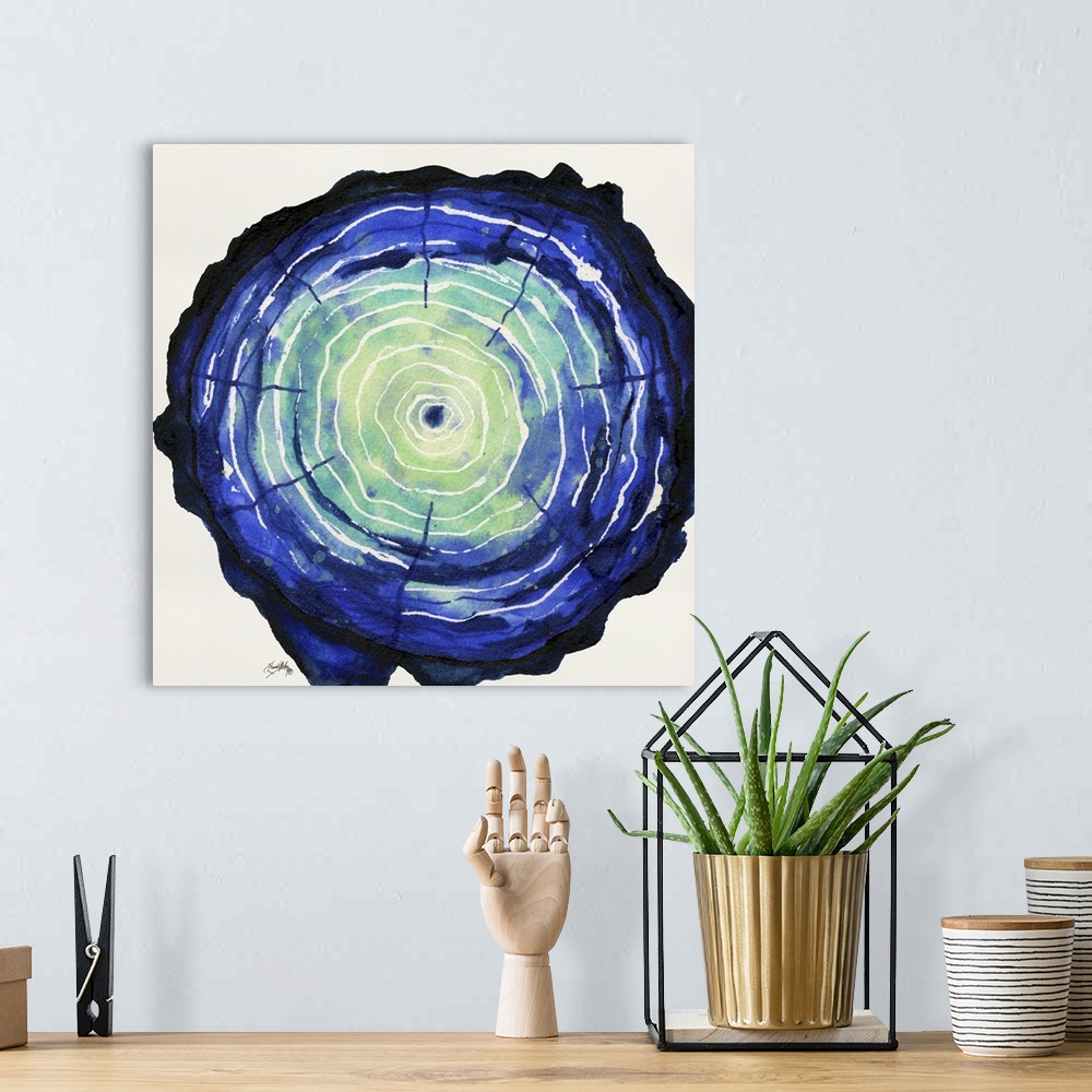 A bohemian room featuring Square watercolor painting of a blue and green tree trunk, highlighting the tree rings in white.