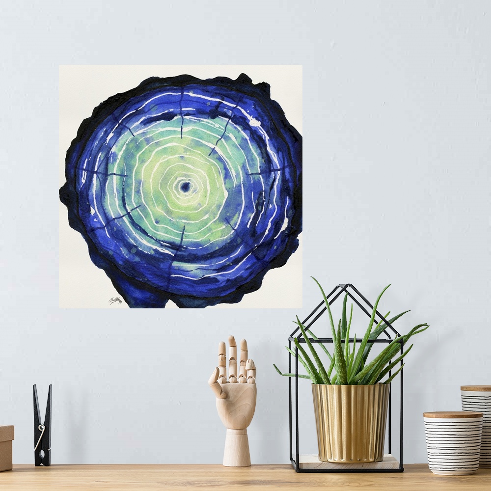 A bohemian room featuring Square watercolor painting of a blue and green tree trunk, highlighting the tree rings in white.