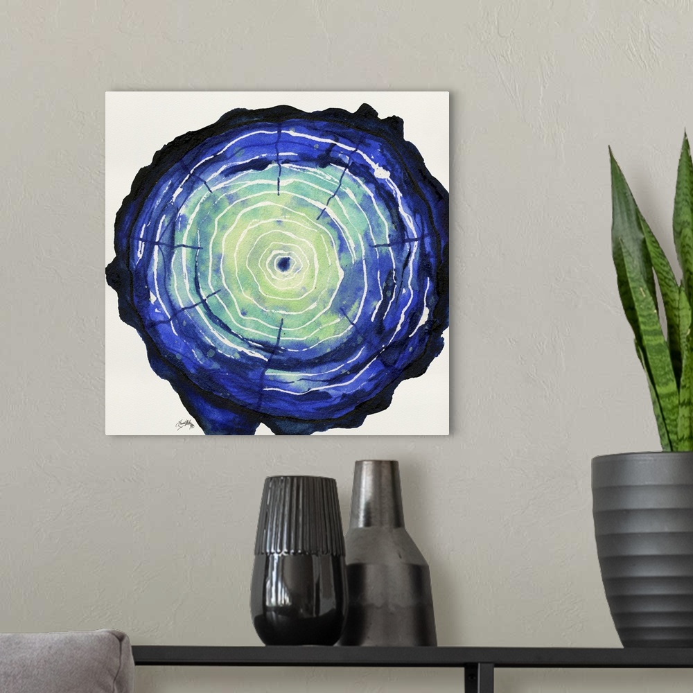A modern room featuring Square watercolor painting of a blue and green tree trunk, highlighting the tree rings in white.