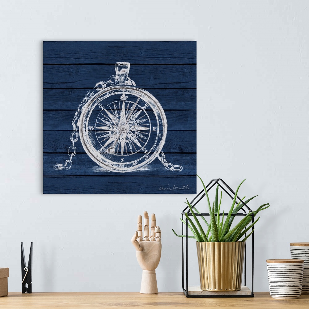 A bohemian room featuring A painting of a white compass on a blue wood paneled background.
