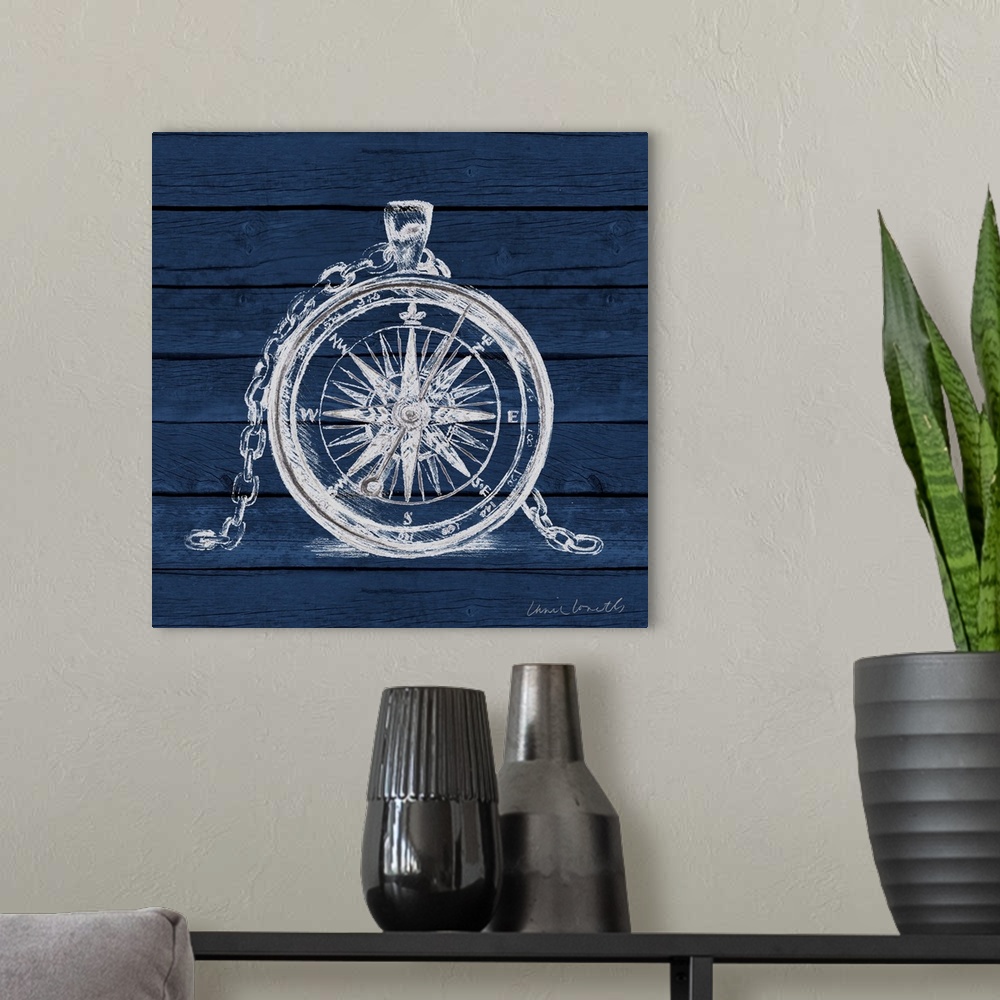 A modern room featuring A painting of a white compass on a blue wood paneled background.
