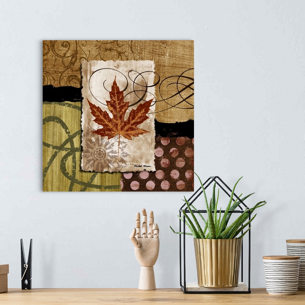 A bohemian room featuring A fall leaf framed with various earth-toned patterns and prints.