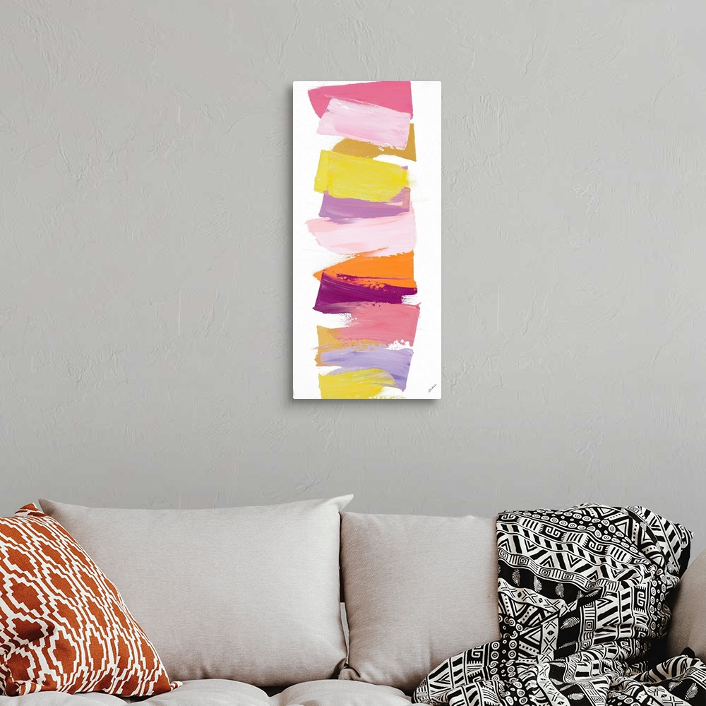 A bohemian room featuring Vertical contemporary painting of shades of pink and yellow stacked in a line.