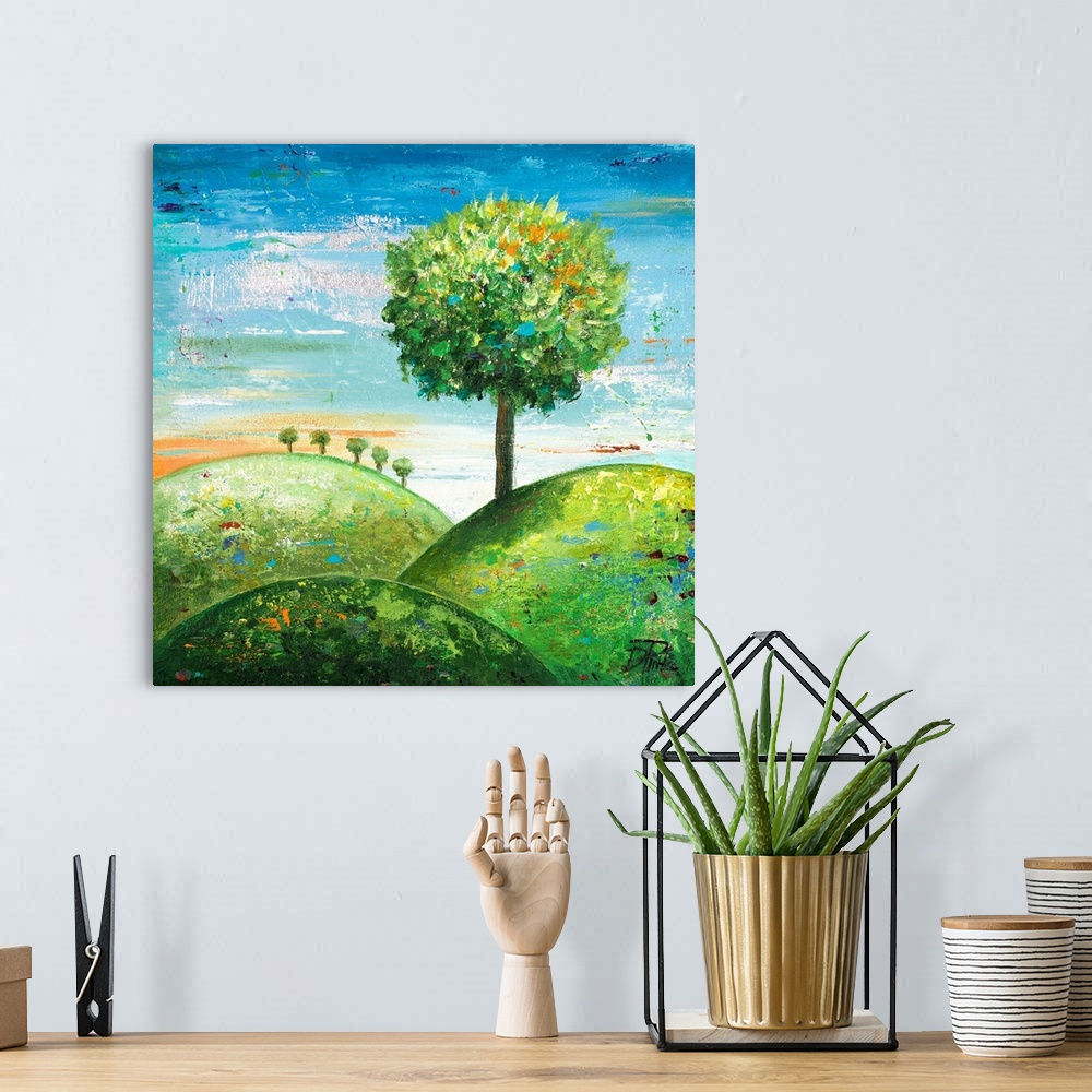A bohemian room featuring Contemporary painting of a round tree on a green hillside.