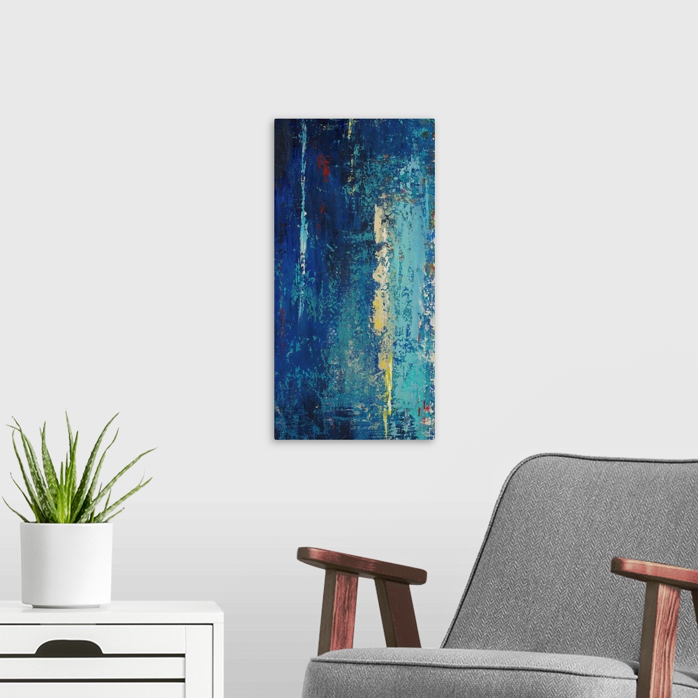 A modern room featuring A contemporary abstract painting with dark blues mixed with light blues, yellows and red.