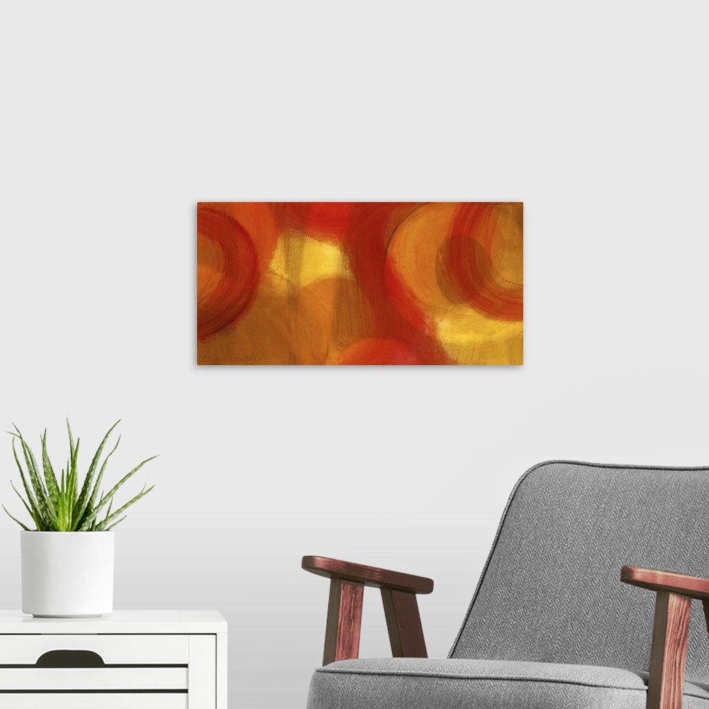 A modern room featuring Long abstractly painted canvas with patches of warm color with circles painted around.