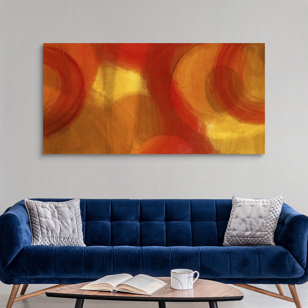 A modern room featuring Long abstractly painted canvas with patches of warm color with circles painted around.