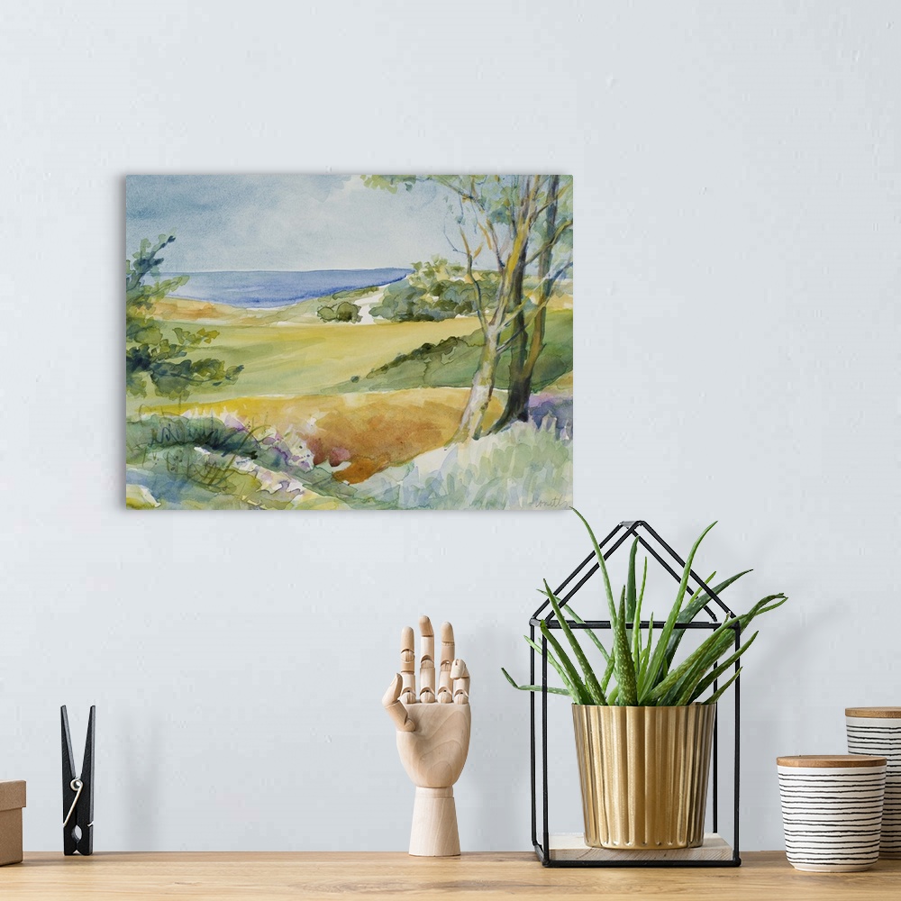 A bohemian room featuring Watercolor landscape painting of trees and bushes overlooking the ocean.