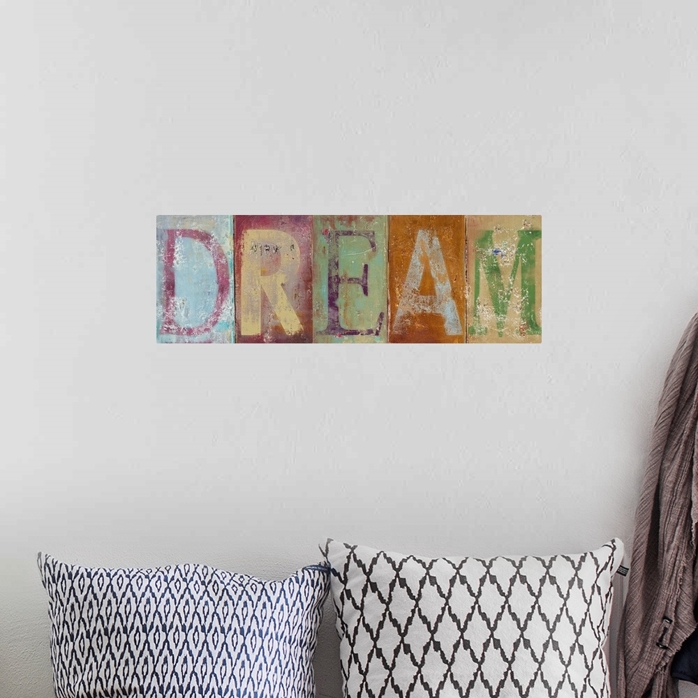 A bohemian room featuring Horizontal typographic artwork of distressed painted letters spelling out an inspirational word.