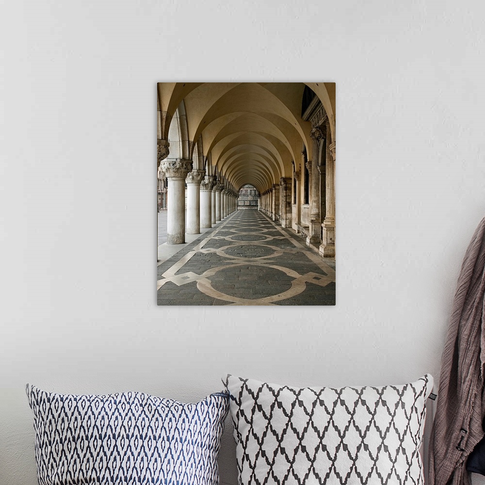 A bohemian room featuring Photograph of a walkway in the Ducale Palace in Urbino, Italy under ornate arches.