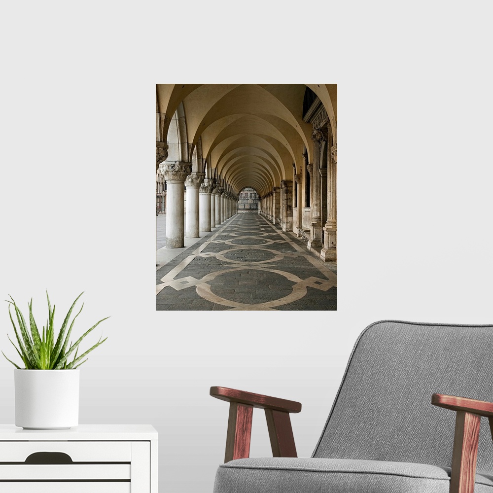 A modern room featuring Photograph of a walkway in the Ducale Palace in Urbino, Italy under ornate arches.