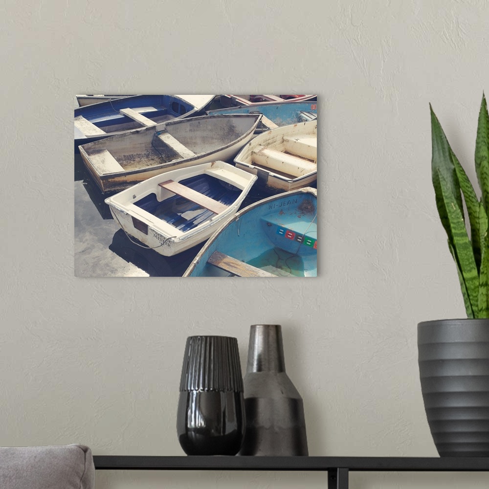 A modern room featuring A photograph of a cluster of worn boats.