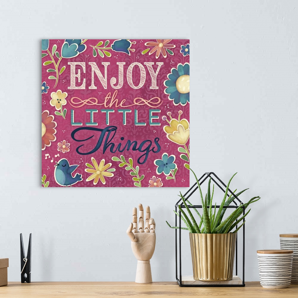 A bohemian room featuring "Enjoy the Little Things" surrounded by flowers and a blue bird.