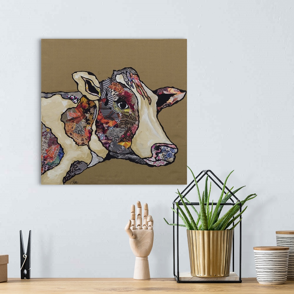A bohemian room featuring Artwork of a cow embellished with collage elements.