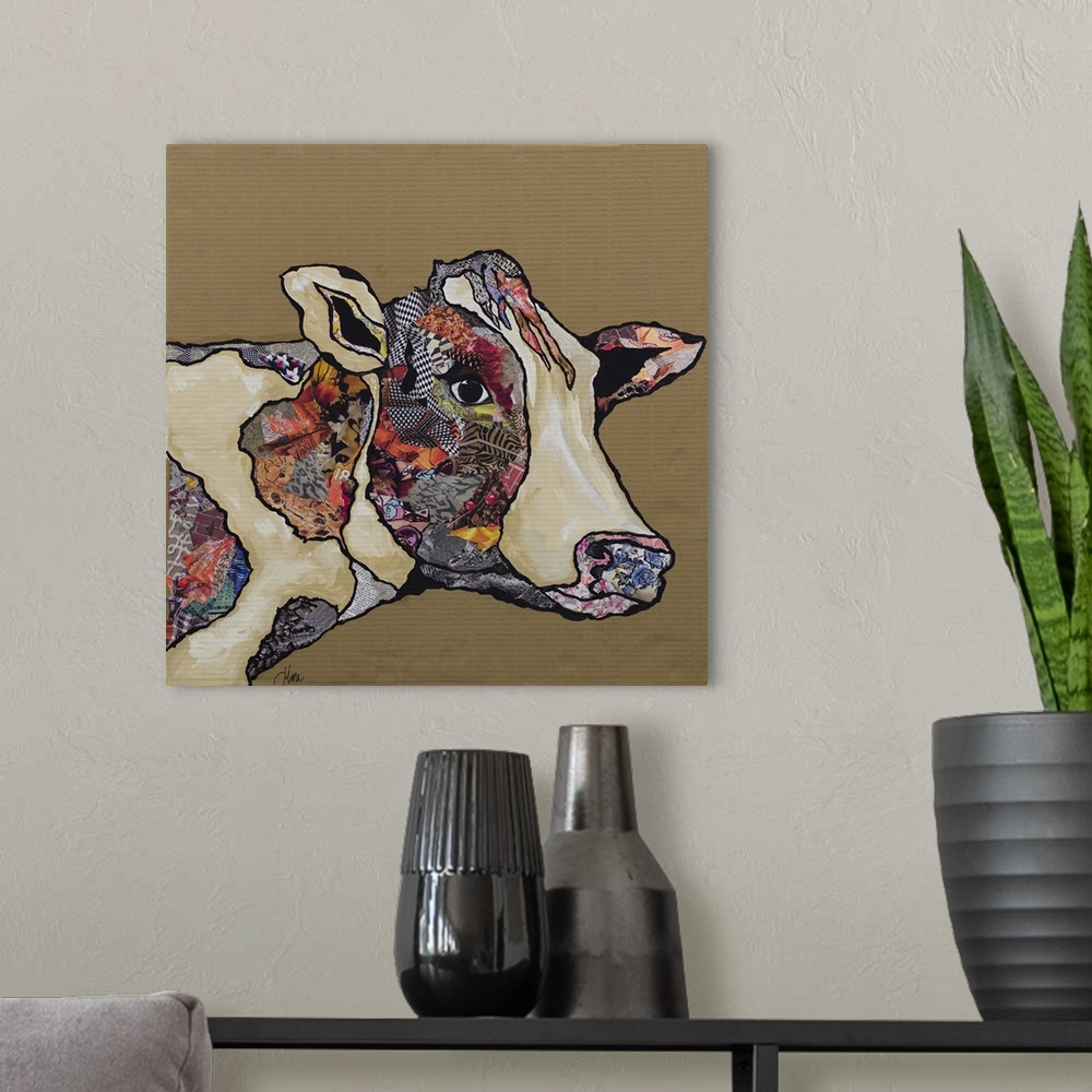 A modern room featuring Artwork of a cow embellished with collage elements.