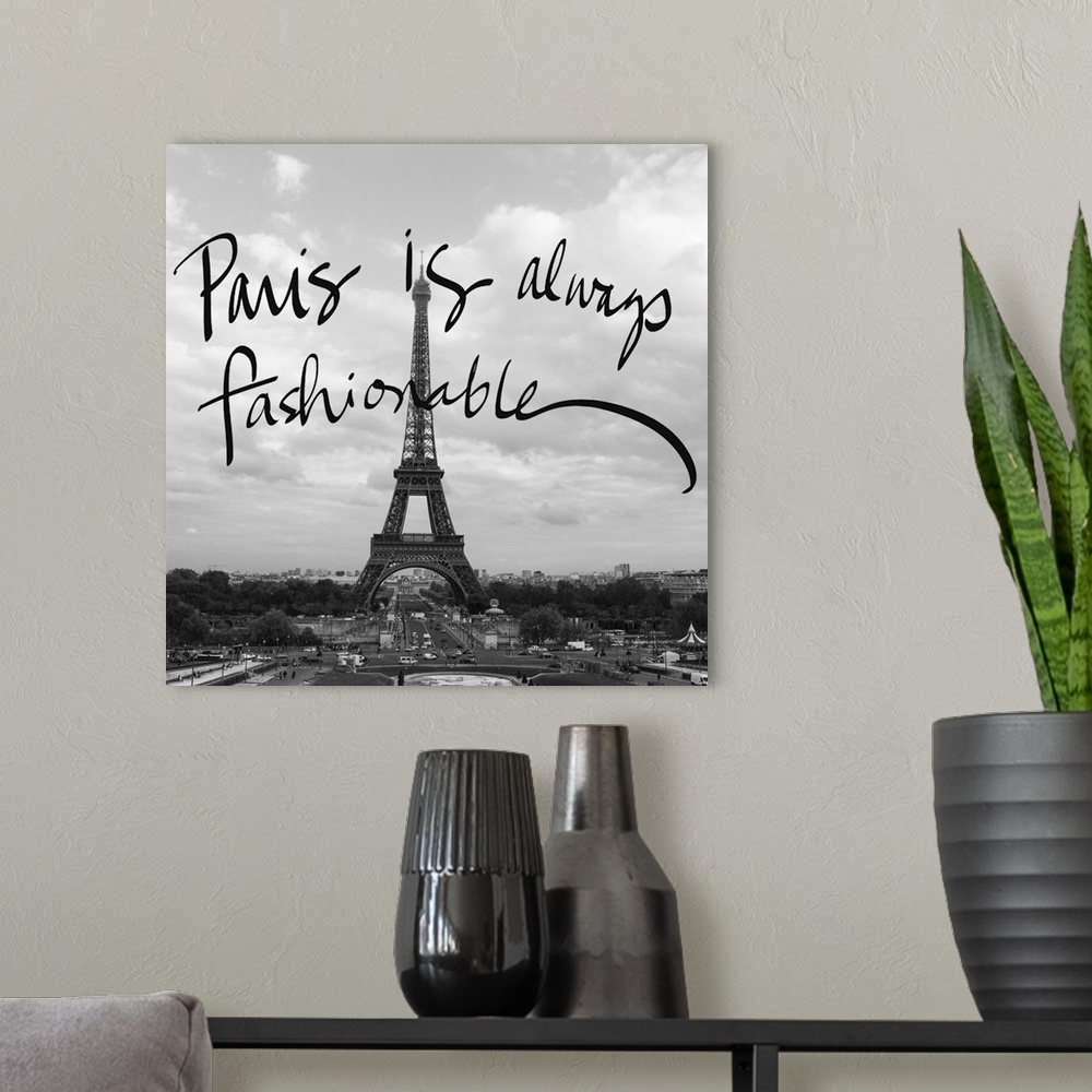 A modern room featuring Black and white photograph of the Eiffel Tower with "Paris is always fashionable" hand-written ov...