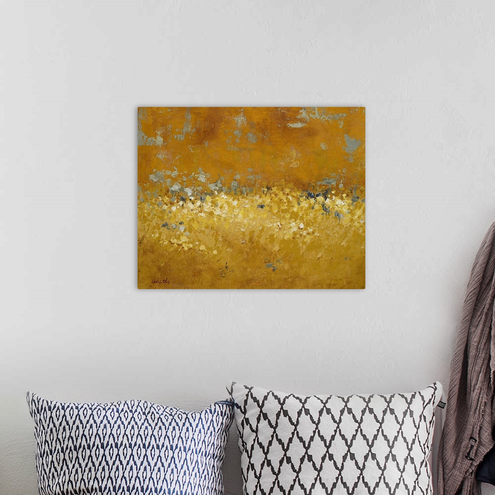 A bohemian room featuring Abstract painting done in golden tones, creating a semblance of a field of wildflowers at sunset.