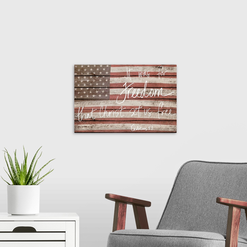A modern room featuring American flag on wooden board with a bible verse handwritten over it.